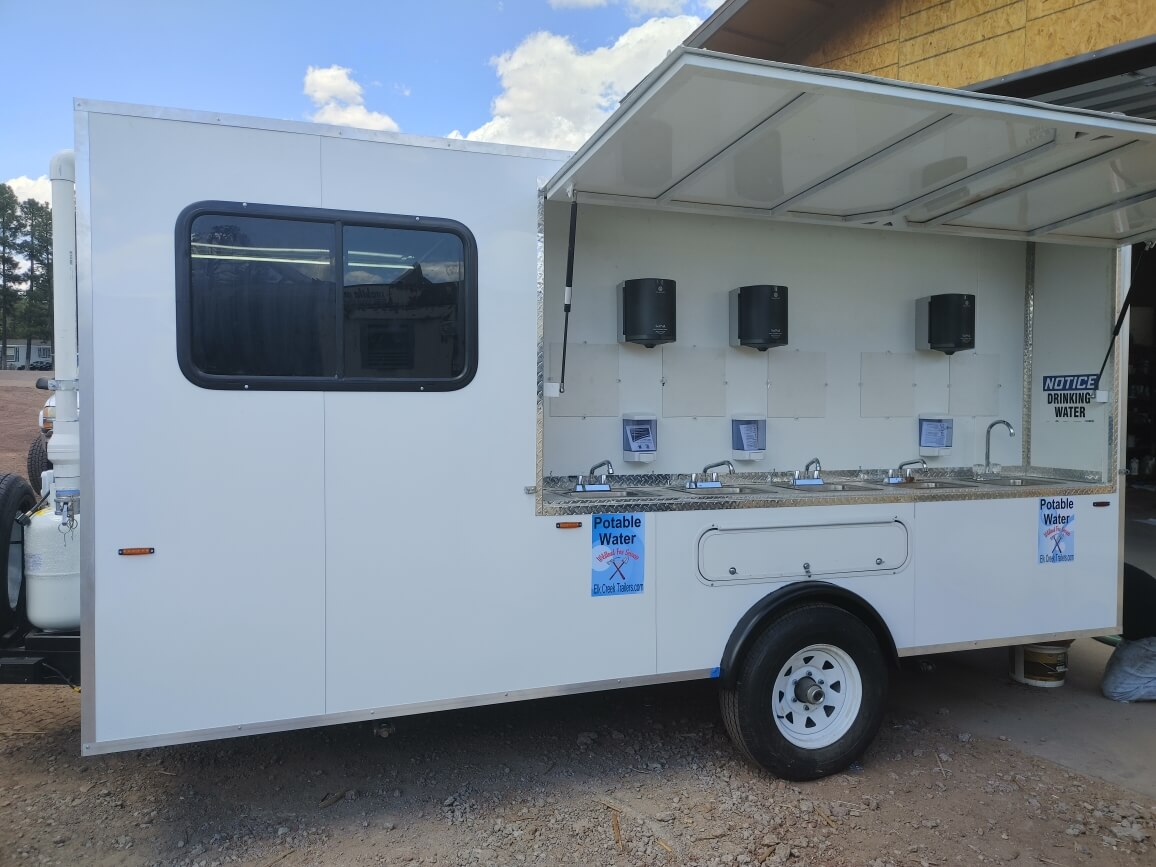 Side view of a 10 sink trailer with stainless steel sinks