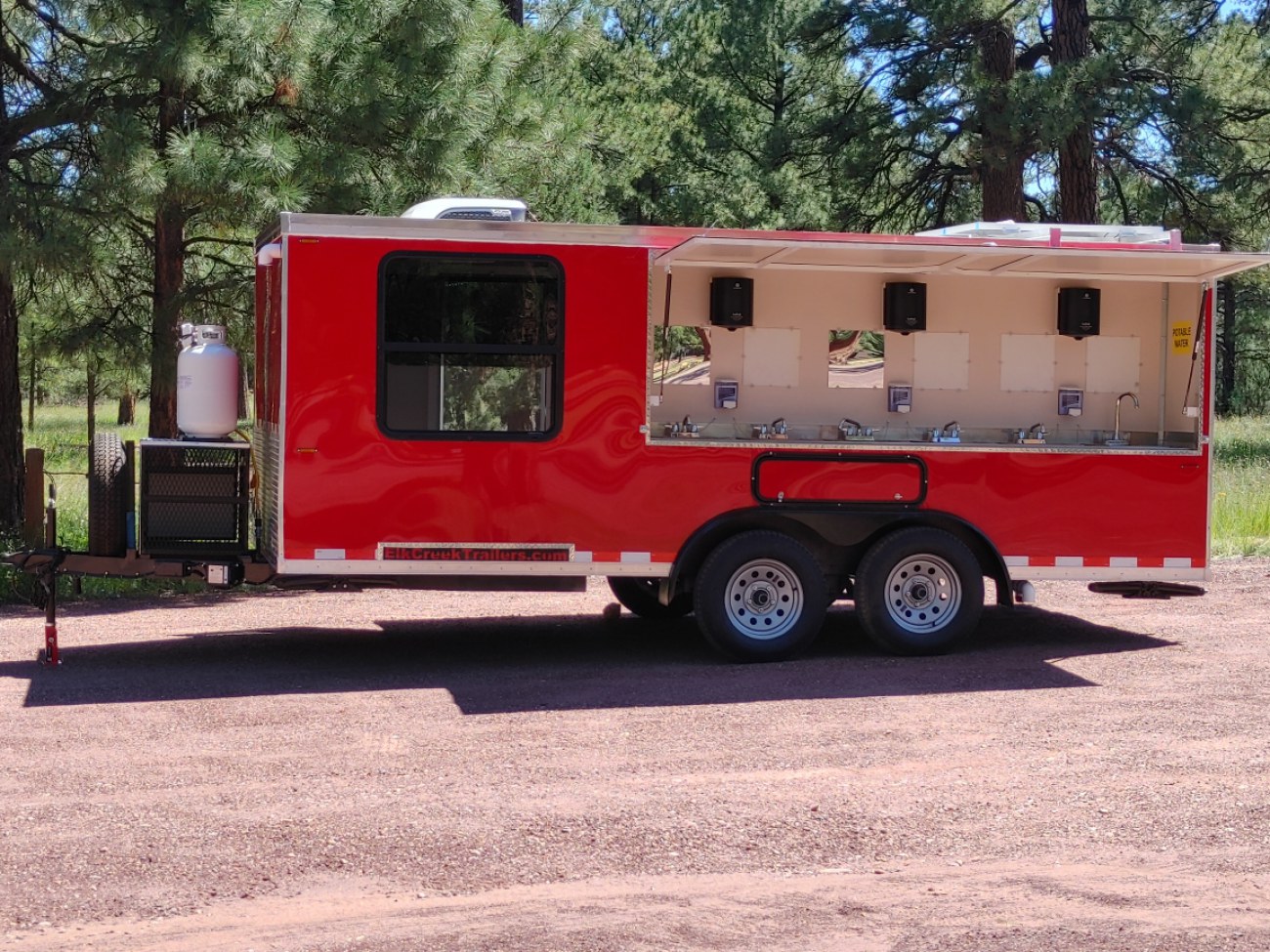 Side view of a 12 sink trailer with stainless steel sinks.